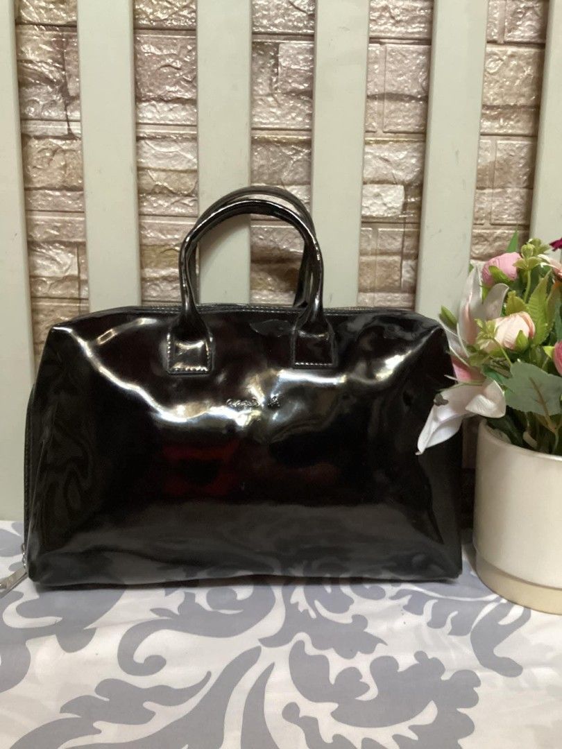 Agnes B. Black Patent Leather Handbag (Category: Luxury Bags & Wallets) located in Santa Rosa. Submitted by ahroncatpad (Listing ID 1398080893, Image 1). Description: - Agnes B. black patent leather handbag - Made of shiny patent leather - Features a top zipper closure - Includes dual top handles - Interior has multiple compartments - Agnes B. logo visible on the front.