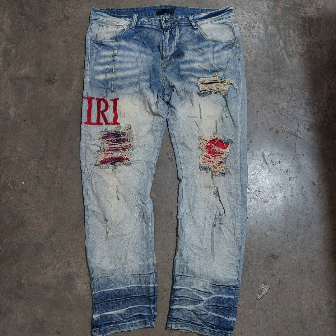 Amiri Distressed Denim Pants (Category: Jeans) located in Tuguegarao City. Submitted by 3500.finds (Listing ID 1398018219, Image 1). Description: - Amiri distressed jeans - Size 36-38 / 40.5 / 7.5 - Color rate 9.5/10 - Light blue wash - Ripped and patched details - Red embroidered accents - Brand name embroidered on back - Made in Italy.