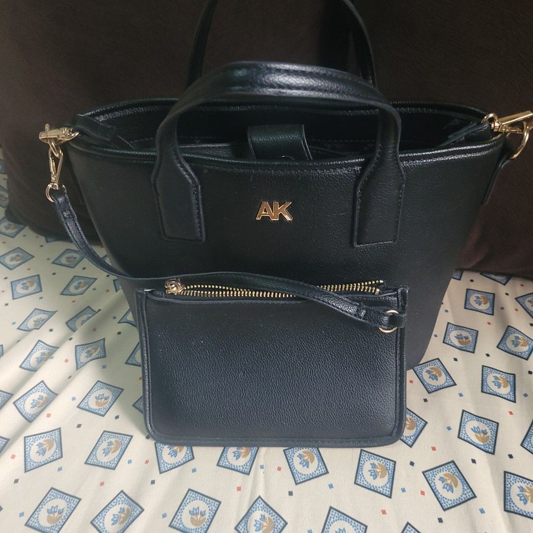 Anne Klein Black Handbag with Wallet (Category: Luxury Bags & Wallets) located in Bulacan. Submitted by butterflym60701 (Listing ID 1397999987, Image 2). Description: - Black Anne Klein handbag with matching wallet. - Gold-tone "AK" logo on the front. - Detachable shoulder strap included. - Interior features a zippered pocket and Anne Klein logo lining. - Top handles and gold-tone hardware. - Matching wallet with zipper closure..