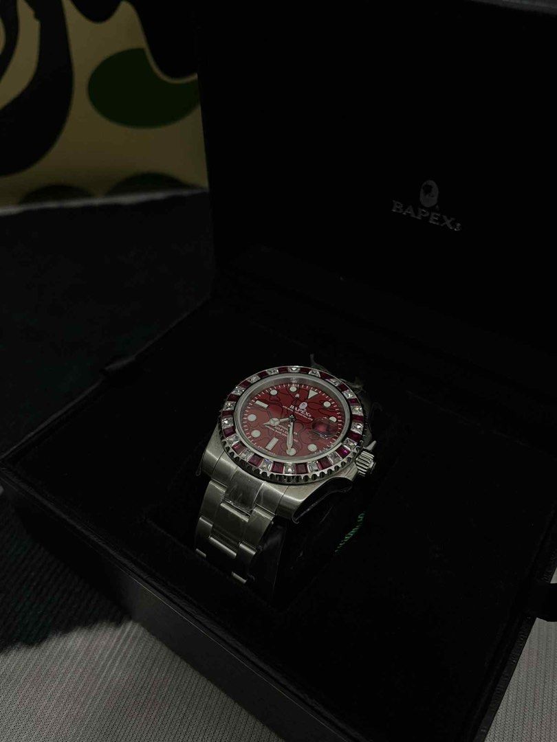 Bapex Type 1 Red Crystal Stone Bezel (Category: Luxury Watches) located in Dumaguete. Submitted by infiniteloot_ (Listing ID 1398111319, Image 1). Description: Bapex watch features a striking red dial and a stainless steel bracelet. It comes with its original box, papers, and a guarantee card. The watch has a bezel with red accents. The watch is a stylish accessory for any occasion..