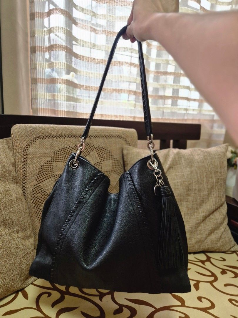 Black Leather Hobo Bag with Tassel (Category: Shoulder Bags) located in Quezon City. Submitted by jermiahh (Listing ID 1398023563, Image 2). Description: - Black leather hobo bag - Braided strap - Silver-tone hardware - Tassel detail - Zipper closure - Slouchy design - Soft leather.