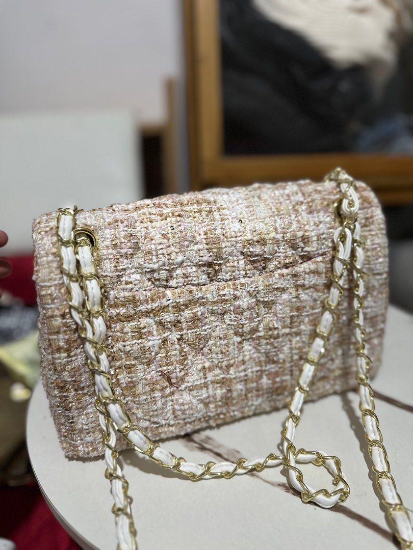 Chanel Tweed Flap Bag (Category: Luxury Bags & Wallets) located in Manila. Submitted by lenore1213 (Listing ID 1398103505, Image 1). Description: - Chanel Flap Bag - Tweed exterior with quilted pattern - Chain strap with white leather accents - Burgundy interior with Chanel logo - Gold-tone clasp closure.