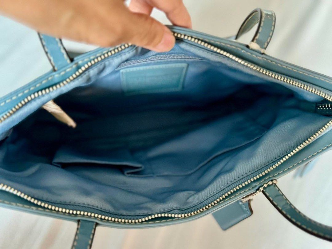 Coach Signature Tote Bag (Category: Luxury Bags & Wallets) located in Manila. Submitted by flojo1220 (Listing ID 1397995850, Image 3). Description: - Authentic Coach tote bag - Signature brown and beige pattern - Light blue trim and handles - Light blue interior with multiple pockets - Includes Coach hangtag - Zip closure - Stylish and functional.