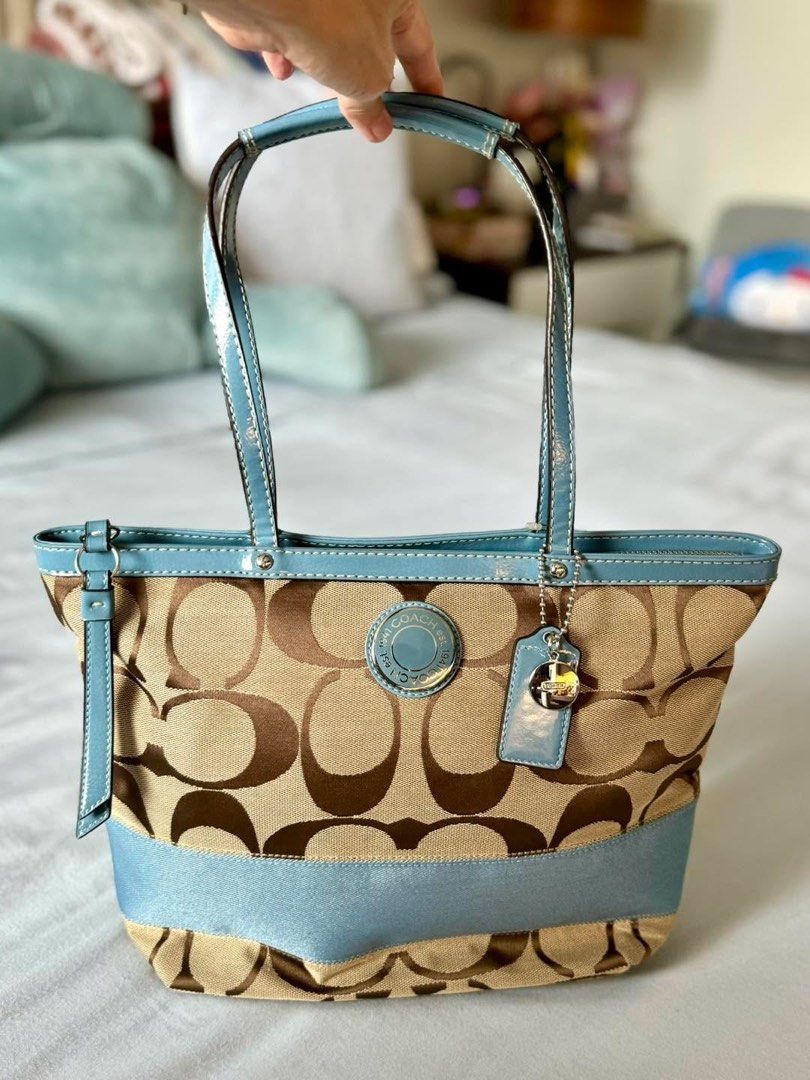 Coach Signature Tote Bag (Category: Luxury Bags & Wallets) located in Manila. Submitted by flojo1220 (Listing ID 1397995850, Image 1). Description: - Authentic Coach tote bag - Signature brown and beige pattern - Light blue trim and handles - Light blue interior with multiple pockets - Includes Coach hangtag - Zip closure - Stylish and functional.