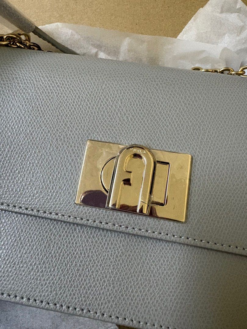 Furla Metropolis Mini Crossbody Bag (Category: Luxury Bags & Wallets) located in Quezon City. Submitted by iamrizzy (Listing ID 1398064302, Image 1). Description: - Authentic Furla Metropolis Mini crossbody bag - Elegant grey color - Gold-tone clasp and chain strap - Includes original tags, dust bag, and box - Purchased from Zalora - Made of genuine leather - Perfect for everyday or special occasions - Stylish and compact design RFS - Small for m