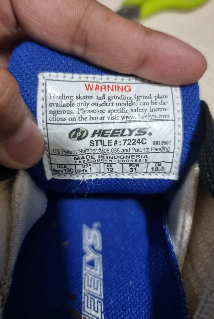 Heelys 7224C Roller Shoes (Category: Sneakers) located in Marikina City. Submitted by andreah_16 (Listing ID 1398079248, Image 2). Description: - Heelys Roller Shoes - Style 7224C - Color: White, Black, and Blue - Size: US 12, UK 11, EUR 31, CM 18 - Includes: Two wheels and stoppers - Features: Laces and Heelys logo - Made in Indonesia.