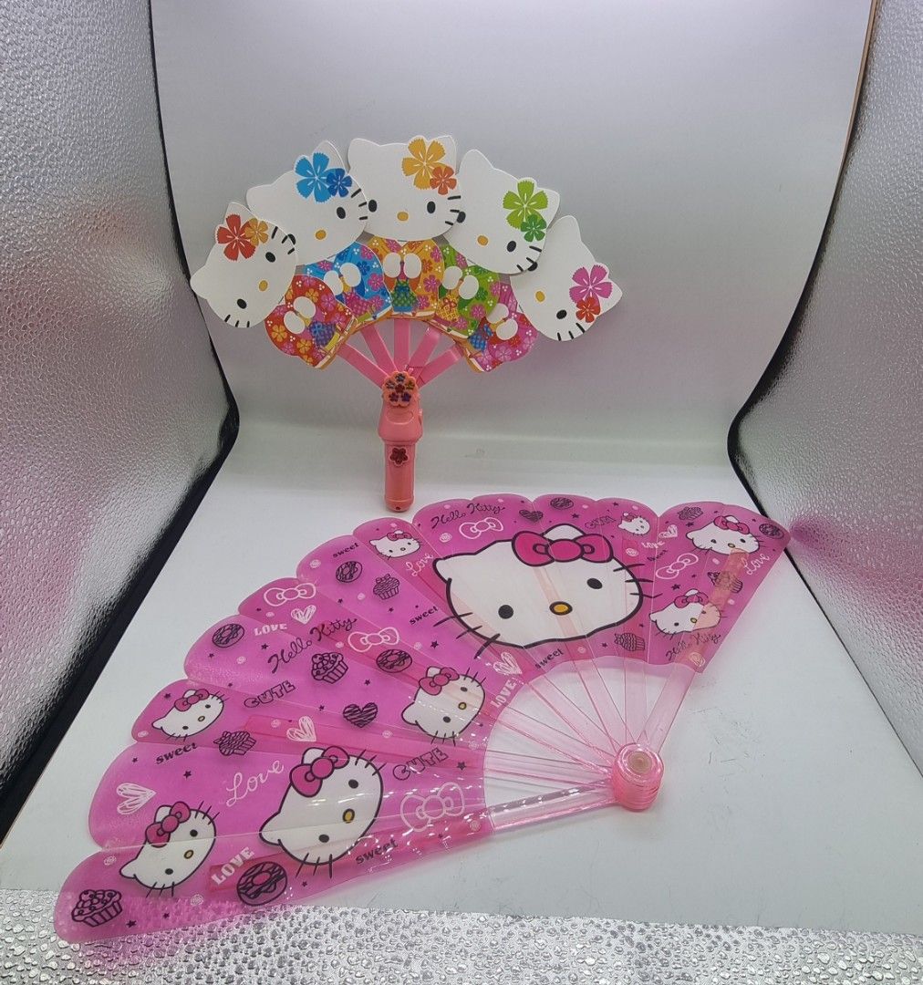 Hello Kitty Handheld Fans (Category: Fans) located in Marikina City. Submitted by andreah_16 (Listing ID 1398081974, Image 2). Description: - Set includes two Kitty fans. - One is a foldable fan with Kitty designs. - The other fan features a Kitty head design. - Both fans are pink. - Both fans feature Kitty..