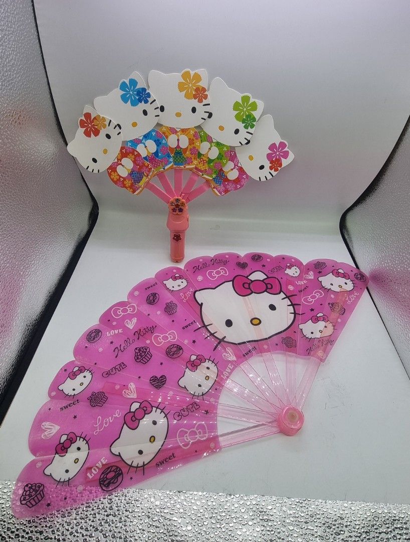 Hello Kitty Handheld Fans (Category: Fans) located in Marikina City. Submitted by andreah_16 (Listing ID 1398081974, Image 1). Description: - Set includes two Kitty fans. - One is a foldable fan with Kitty designs. - The other fan features a Kitty head design. - Both fans are pink. - Both fans feature Kitty..