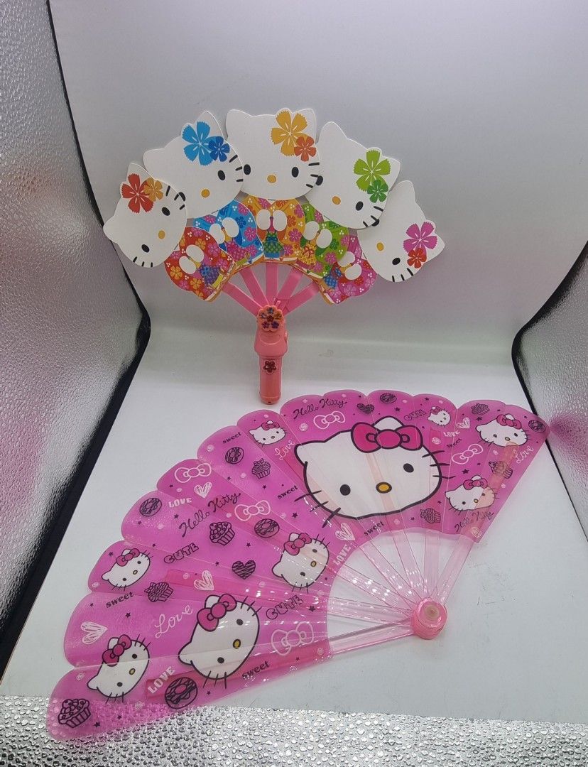 Hello Kitty Handheld Fans (Category: Fans) located in Marikina City. Submitted by andreah_16 (Listing ID 1398081974, Image 3). Description: - Set includes two Kitty fans. - One is a foldable fan with Kitty designs. - The other fan features a Kitty head design. - Both fans are pink. - Both fans feature Kitty..