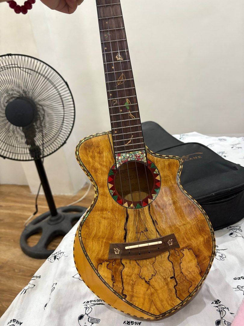 Hricane Ukulele with bag (Category: Musical Instruments) located in Imus. Submitted by plnmn999 (Listing ID 1398066654, Image 2). Description: - Hurricane ukulele with unique wood grain - Decorative soundhole and fretboard inlays - Includes a black carrying case - Black tuning pegs - Cutaway design for easy fret access - Well-maintained super ganda in person! mint condition like amoy bago pa talaga inclusion: strap, tuner, extra strings, microfib