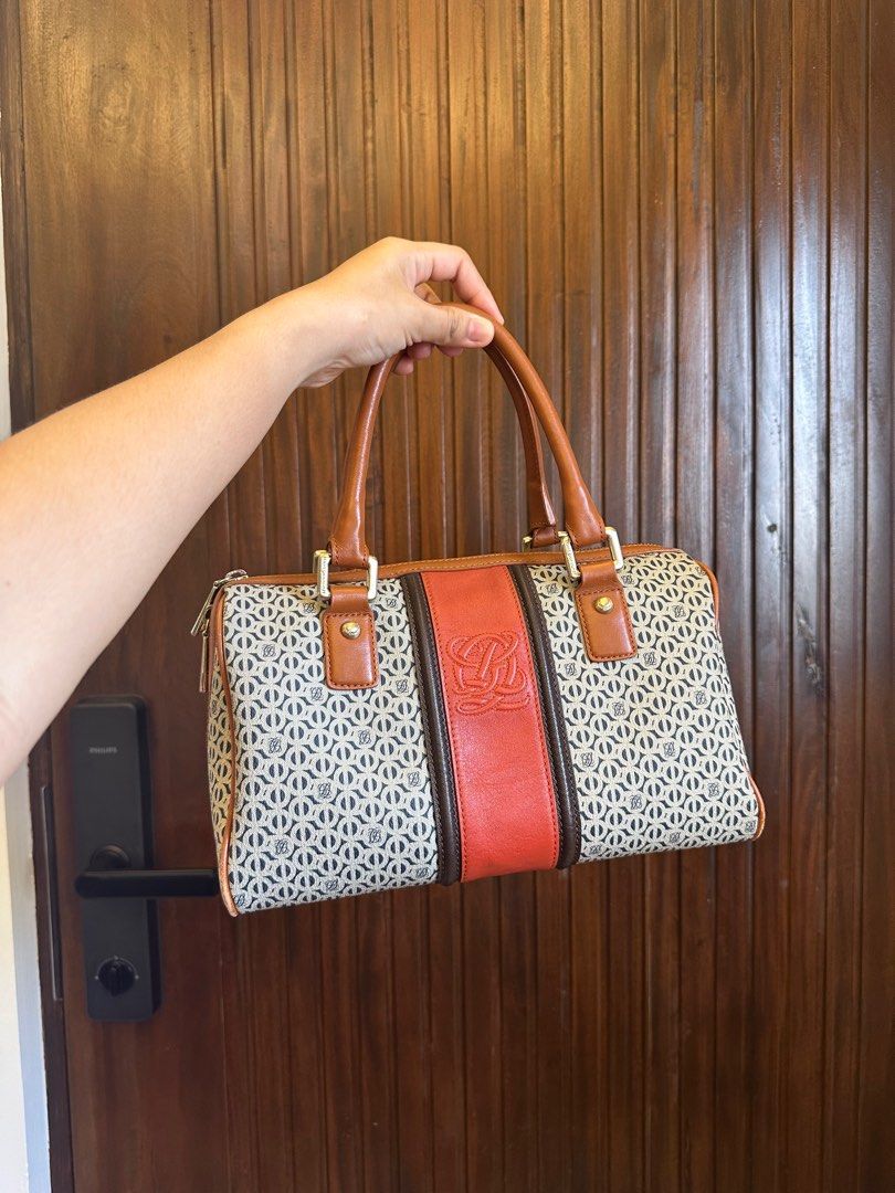 Louis Quatorze (Category: Luxury Bags & Wallets) located in Dagupan City. Submitted by thymeph (Listing ID 1398018300, Image 1). Description: - Unique patterned handbag - very durable - comes with authenticity cards - Eye-catching orange stripe detail - Brown leather handles and accents - Secure zipper closure - Features a logo on the front - Stylish and fashionable design.