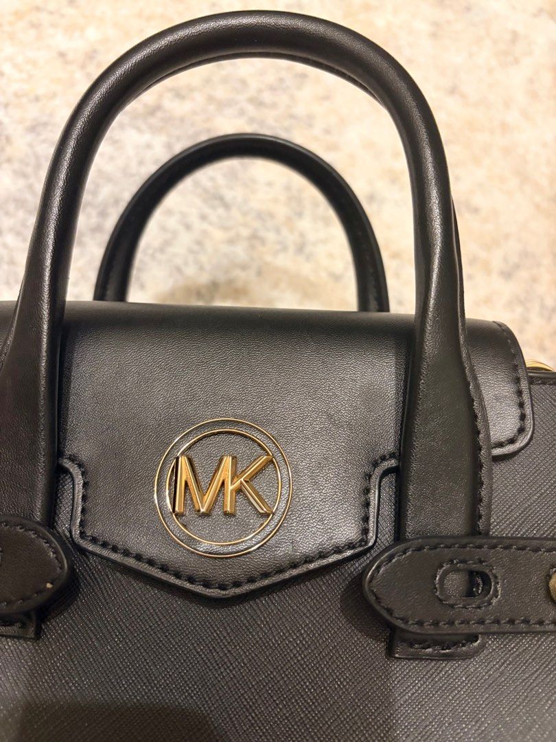 Michael Kors convertible top handle /Satchel Bag (Category: Luxury Bags & Wallets) located in Makati City. Submitted by decluttering_28 (Listing ID 1398114456, Image 2). Description: - Authentic Michael Kors satchel bag -bought in los angeles - Color: Black - Features: Top handle, adjustable shoulder strap, gold-tone MK logo - Design: Structured with flap closure - Material: Textured.