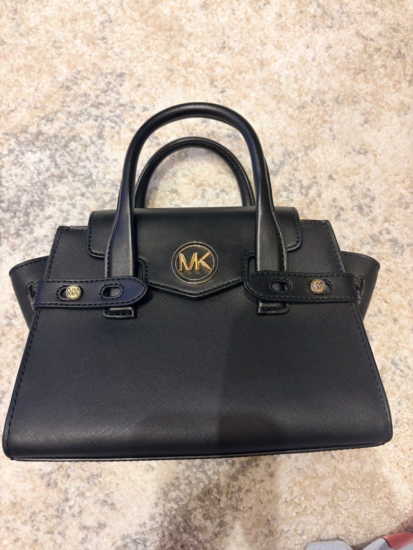 Michael Kors convertible top handle /Satchel Bag (Category: Luxury Bags & Wallets) located in Makati City. Submitted by decluttering_28 (Listing ID 1398114456, Image 1). Description: - Authentic Michael Kors satchel bag -bought in los angeles - Color: Black - Features: Top handle, adjustable shoulder strap, gold-tone MK logo - Design: Structured with flap closure - Material: Textured.