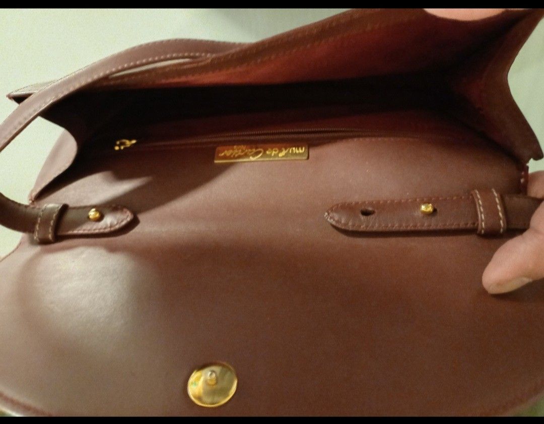 Must de Cartier Shoulder Bag (Category: Luxury Bags & Wallets) located in Quezon City. Submitted by mset.05011984 (Listing ID 1398116033, Image 1). Description: Elegant Must de Cartier shoulder bag in a rich brown color. Features a flap closure with a gold-tone clasp and a long shoulder strap. The interior includes a zippered pocket and the Must de Cartier logo. The bag has a classic design with visible stitching details..