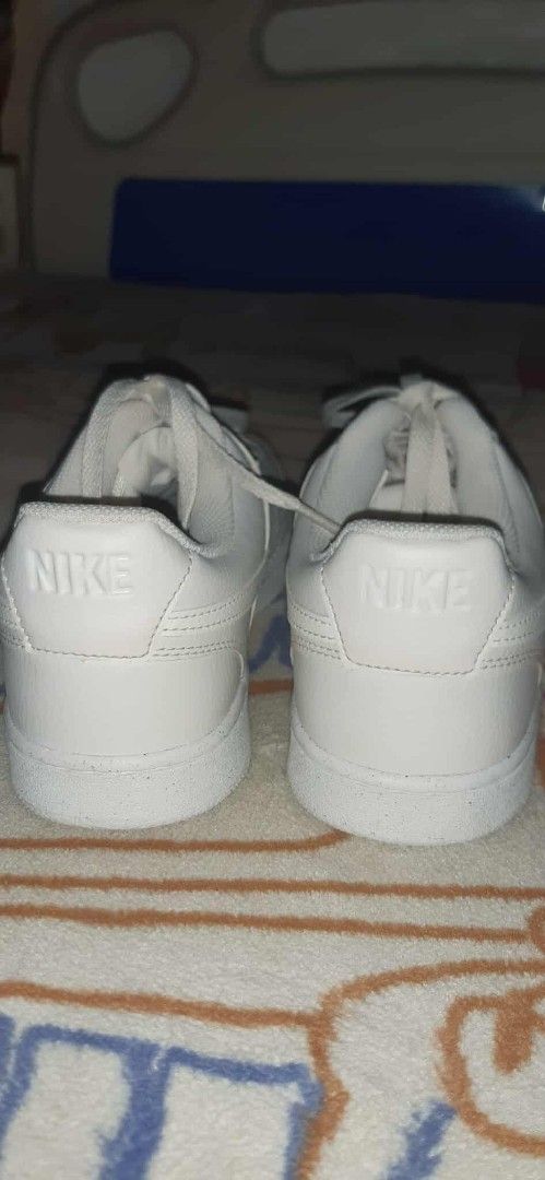 Nike Court Vision Low White Sneakers (Category: Sneakers) located in Plaridel. Submitted by luckyhat (Listing ID 1398024302, Image 1). Description: - Nike Court Vision Low sneakers - White color - Nike logo on heel and side - Lace-up closure - Perforated toe box - White soles.