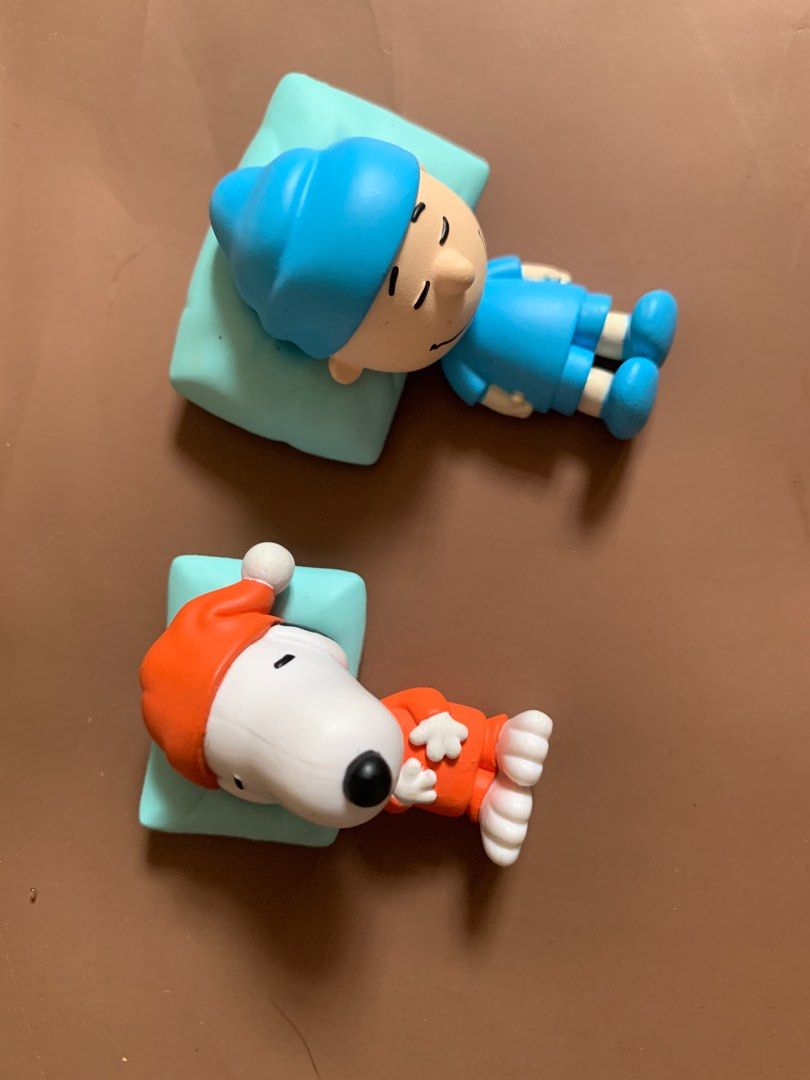 Peanuts Snoopy and Charlie Brown Figurines (Category: Figurines & Statues) located in Quezon City. Submitted by thriftuhf (Listing ID 1398023920, Image 1). Description: 150 each! - Adorable Snoopy and Charlie Brown figurines. - Both are in sleeping poses. - Snoopy wears an orange outfit and hat. - Charlie Brown is in blue pajamas and a nightcap. - Resting on light blue pillows. - Great addition to any Peanuts collection..