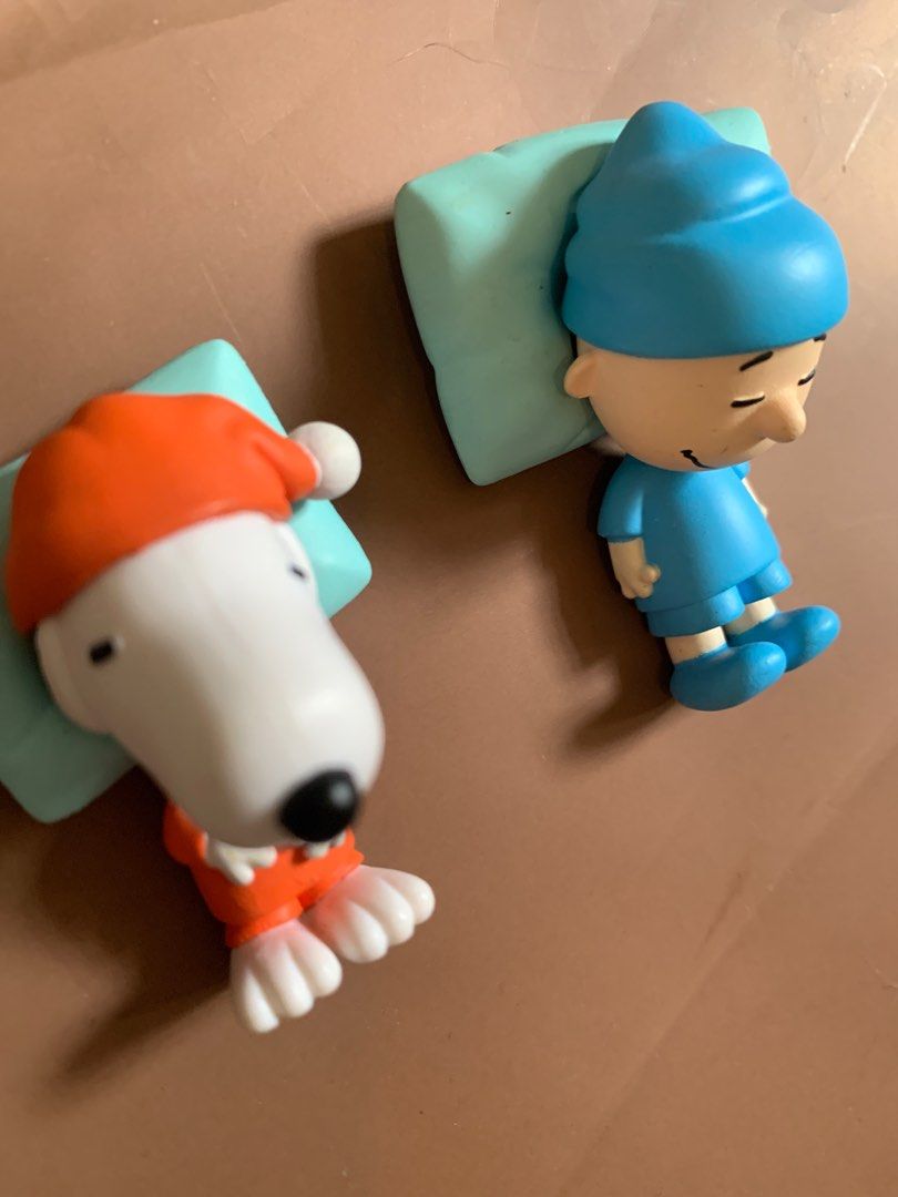 Peanuts Snoopy and Charlie Brown Figurines (Category: Figurines & Statues) located in Quezon City. Submitted by thriftuhf (Listing ID 1398023920, Image 2). Description: 150 each! - Adorable Snoopy and Charlie Brown figurines. - Both are in sleeping poses. - Snoopy wears an orange outfit and hat. - Charlie Brown is in blue pajamas and a nightcap. - Resting on light blue pillows. - Great addition to any Peanuts collection..