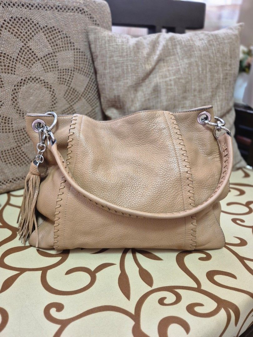 Tan Leather Hobo Bag with Tassel (Category: Shoulder Bags) located in Quezon City. Submitted by jermiahh (Listing ID 1398025019, Image 2). Description: - Tan leather hobo bag - Stitched handle - Stylish tassel - Soft, slouchy design - Silver-tone hardware - Comfortable shoulder strap - Versatile for everyday use - Neutral color.