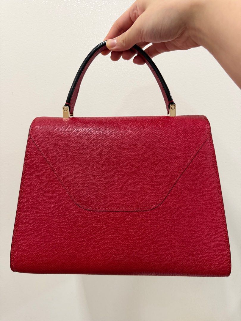 Valextra Iside Top Handle Bag Medium (Category: Luxury Bags & Wallets) located in Quezon City. Submitted by prelovedbyncy (Listing ID 1397988618, Image 2). Description: - Valextra Iside Top Handle Bag - Medium size - Striking red color - Elegant design - Includes original strap and tags Bag was never used. In like new condition. Includes tags and dustbag only.