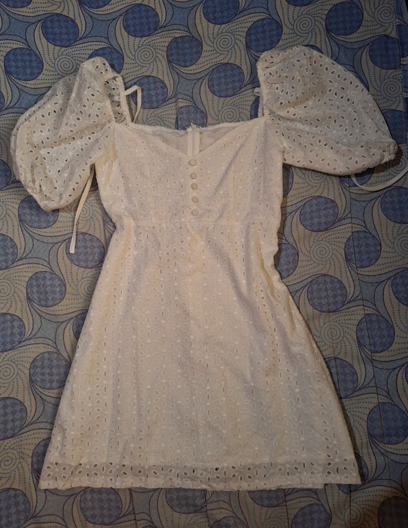White Eyelet Dress with Puff Sleeves (Category: Dresses) located in Daet. Submitted by sabarcavy_ (Listing ID 1397993202, Image 1). Description: - White eyelet dress - Square neckline - Puff sleeves - Fitted bodice with button details - Flared skirt - Adjustable straps - Back zipper closure - Ideal for summer outings.