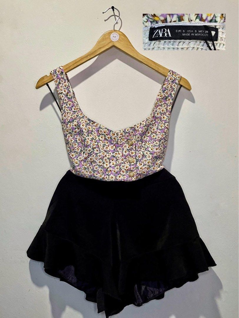 Zara Top (Category: Blouses) located in Cavite. Submitted by jaydaascollection (Listing ID 1398013486, Image 1). Description: Zara floral top with button details. Features a square neckline and thick straps. The top has a daisy print and is made in Morocco. Size S. The top is paired with black shorts in the first image..