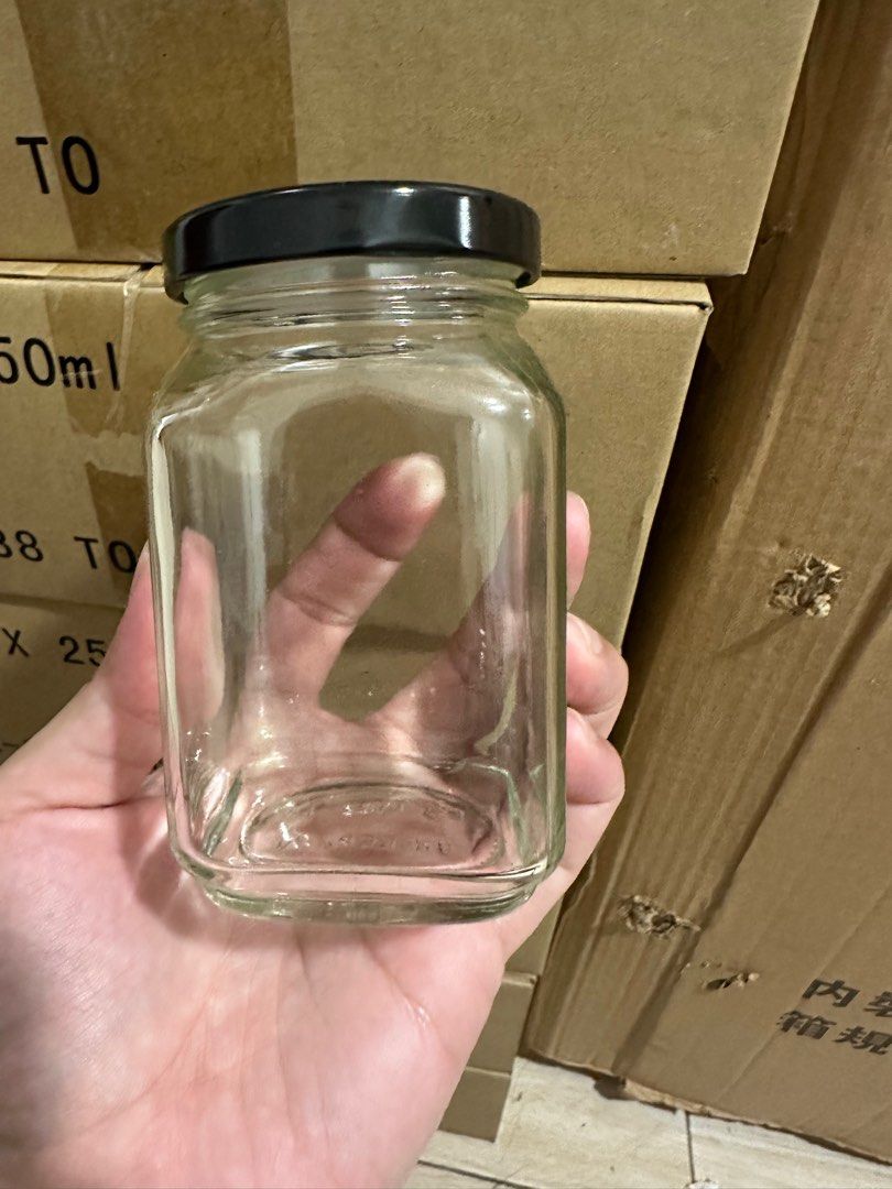 250ml Glass Jar with Black Lid (Category: Food Organization & Storage) located in Manila. Submitted by chris.1995 (Listing ID 1398231175, Image 3). Description: - 24 square glass jars - Black lids - 250ml capacity per jar - 'GLASS Handle with care' label included.