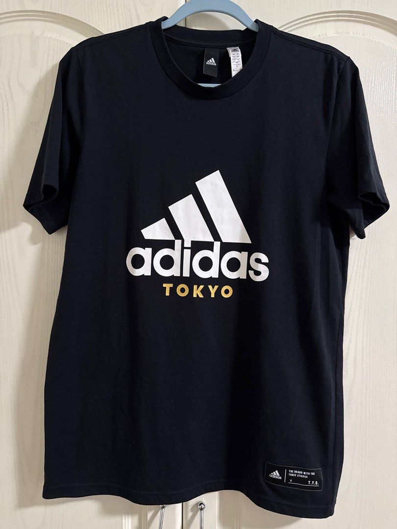 Adidas Tokyo T-shirt (Category: Tshirts & Polo Shirts ) located in Makati City. Submitted by dpfran (Listing ID 1398188741, Image 1). Description: - Adidas Tokyo T-shirt - Color: Black - Material: Polyester - Design: Adidas logo and "TOKYO" print on the front - Neckline: Crew neck - L: 27.5”, W: 16.5” - Sleeves: Short sleeves.