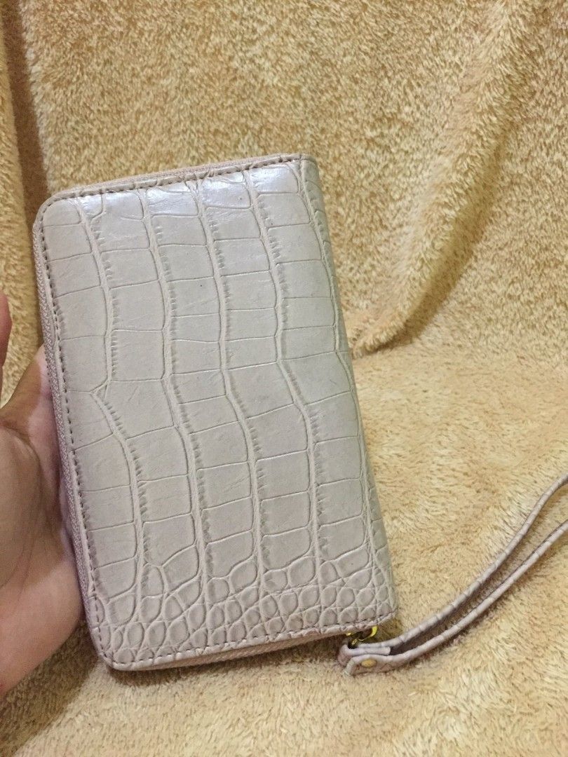 Beige Long Wallet (Category: Wallets & Card holders) located in Bulacan. Submitted by assorted.items (Listing ID 1398281695, Image 1). Description: - Beige crocodile-embossed exterior - Zip-around closure - Multiple card slots - Interior pocket - Includes wrist strap - Gold-toned zipper - Interior: Lighter beige.