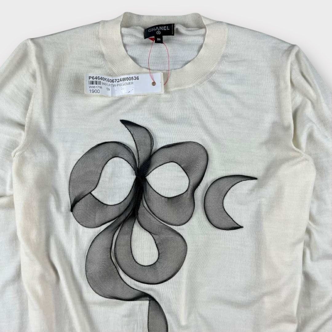 Chanel - Camelia Blooming Knit Wool Jumper Top (Category: Longsleeves) located in Los Banos. Submitted by declutterking (Listing ID 1398337366, Image 2). Description: Size 36 on tag Made of knitted wool. It has a silver hardware at the hem. Material: 100% virgin wool Dimensions: 13" shoulders 17.5" chest 21.75" length 23.5" sleeves 10.25" hem Brand new with tag Authentic .