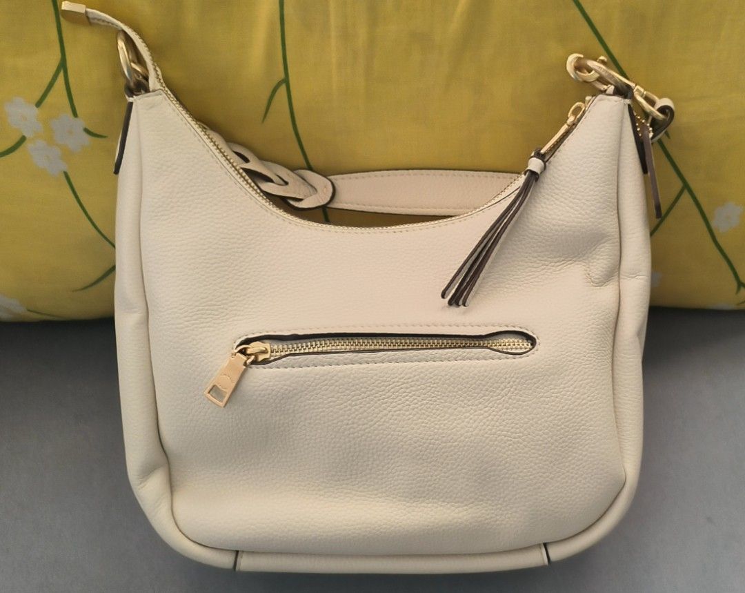 Coach Cream Leather Hobo Bag (Category: Luxury Bags & Wallets) located in Paranaque City. Submitted by dacucs.24 (Listing ID 1398291532, Image 2). Description: -Mirror copy ₱900 - Cream-colored Coach hobo bag - Top zipper closure - Exterior zippered pocket - Gold-tone hardware - Coach logo on front.