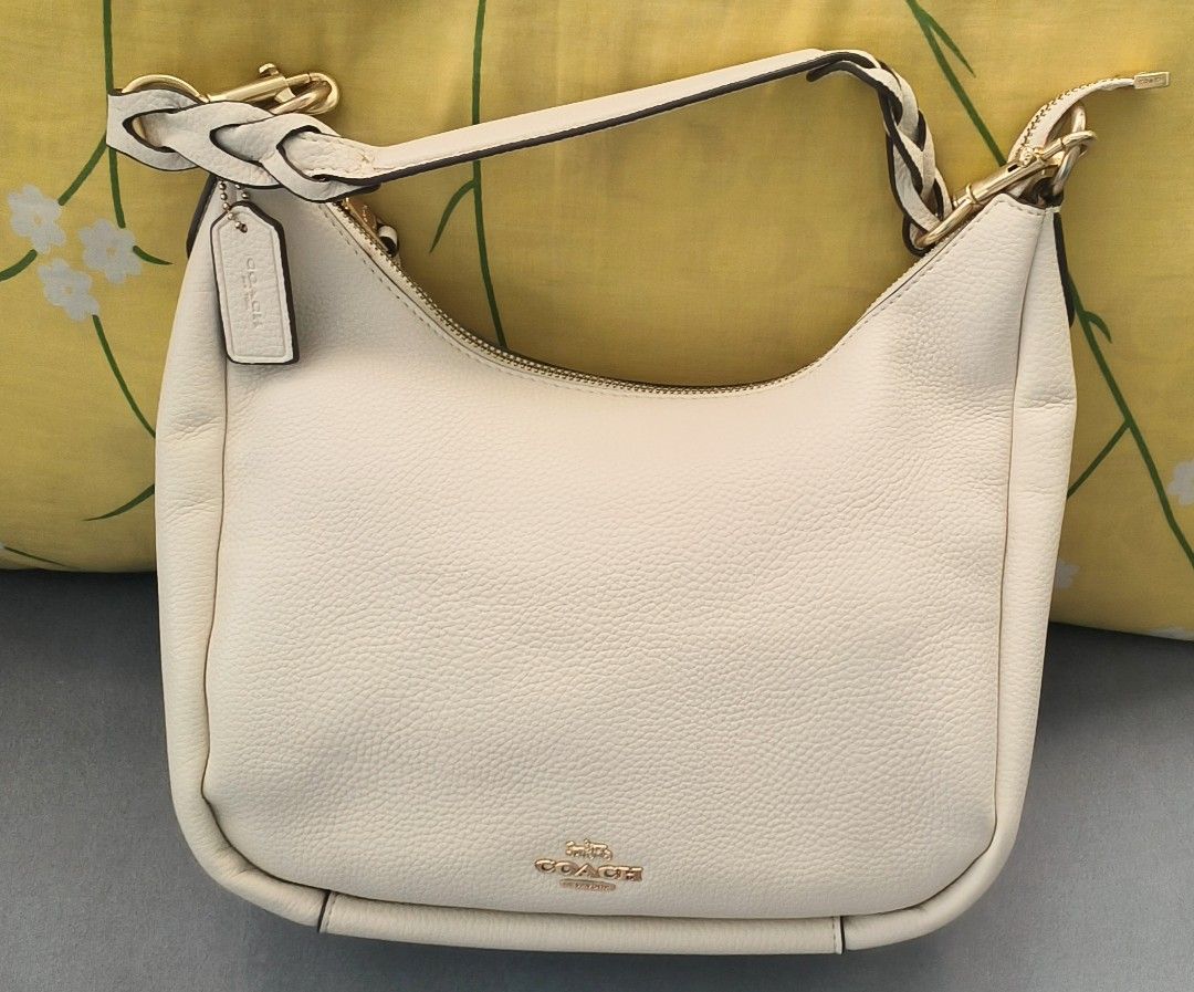 Coach Cream Leather Hobo Bag (Category: Luxury Bags & Wallets) located in Paranaque City. Submitted by dacucs.24 (Listing ID 1398291532, Image 1). Description: -Mirror copy ₱900 - Cream-colored Coach hobo bag - Top zipper closure - Exterior zippered pocket - Gold-tone hardware - Coach logo on front.