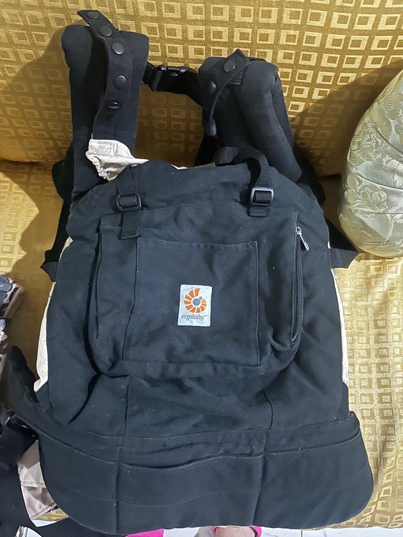 Ergobaby Baby Carrier (Category: Carriers & Slings) located in Manila. Submitted by yesh_ie (Listing ID 1398178999, Image 2). Description: - Ergobaby baby carrier - Black exterior, beige - Features a front pocket - Adjustable straps for a comfortable fit - Perfect for on-the-go parents - Safe and secure for your baby.