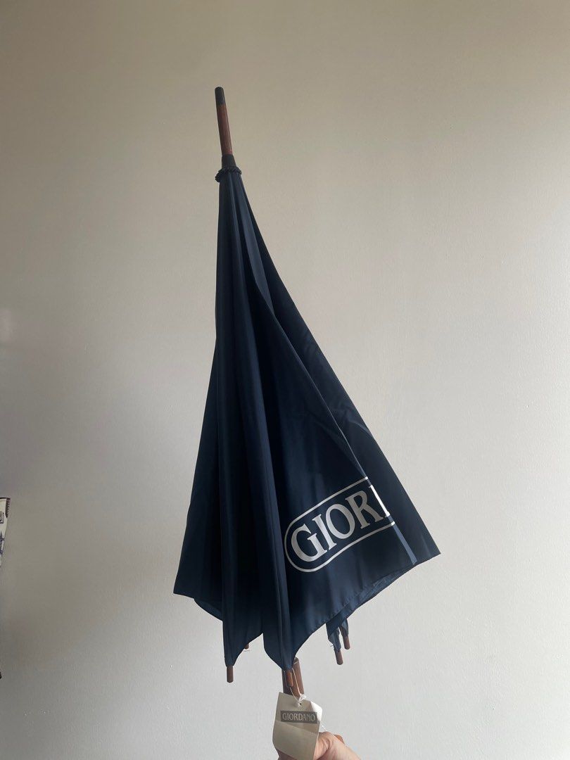 Giordano Umbrella (Category: Umbrellas) located in Manila. Submitted by winnieyols (Listing ID 1398246298, Image 3). Description: BRAND: GIORDANO Giordano umbrella with a wooden handle. The umbrella is navy blue and has the Giordano logo printed on it. The handle is curved and has the brand name engraved. - PHP 900.00 RFS: HELPING MY SISTER DECLUTTER. MOP: BPI SELF BOOK YOUR OWN COURIER FOR PICKUP. SF ON BUYER’S ACCOUNT .