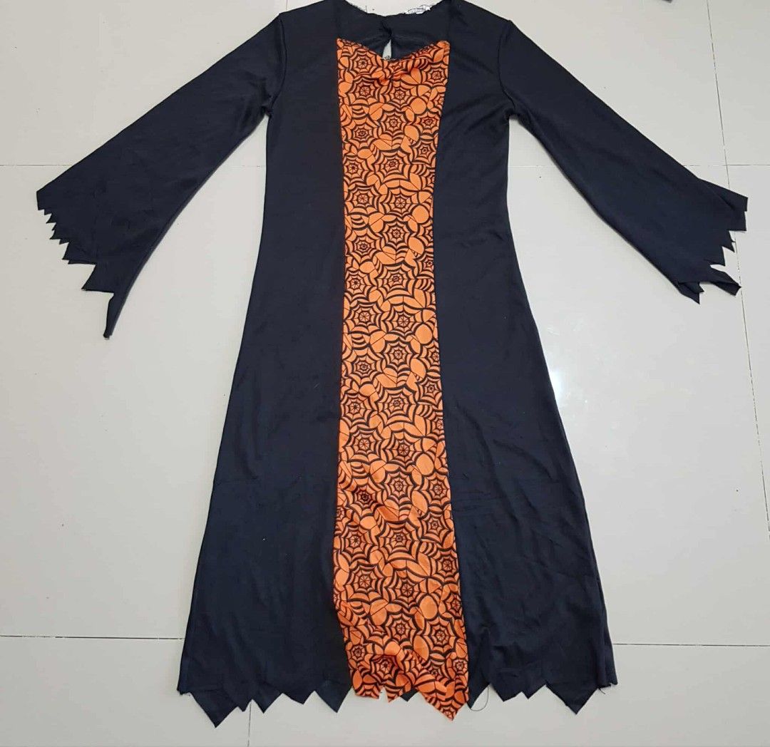 Halloween Witch Costume (Category: Babies & Kids Fashion) located in General Santos City (Dadiangas). Submitted by zafshop8 (Listing ID 1398318089, Image 1). Description: For 7-10 yers old estimate preloved in excellent condition Halloween costume features a black dress with long sleeves and a jagged hemline. The front of the dress has an orange panel with a spiderweb pattern. The dress has a keyhole detail at the neckline. Perfect for Halloween 