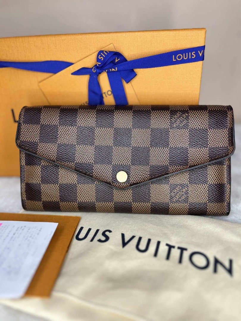 Louis Vuitton Damier Ebene Sarah Wallet (Category: Luxury Bags & Wallets) located in Manila. Submitted by besa8 (Listing ID 1398293570, Image 1). Description: - Authentic Louis Vuitton Sarah Wallet - Damier Ebene canvas - Pink leather interior - Multiple card slots and compartments - Includes original box, dust bag, and receipt - Initials "RTF" embossed inside - Made in Spain - Date code: CA3198.