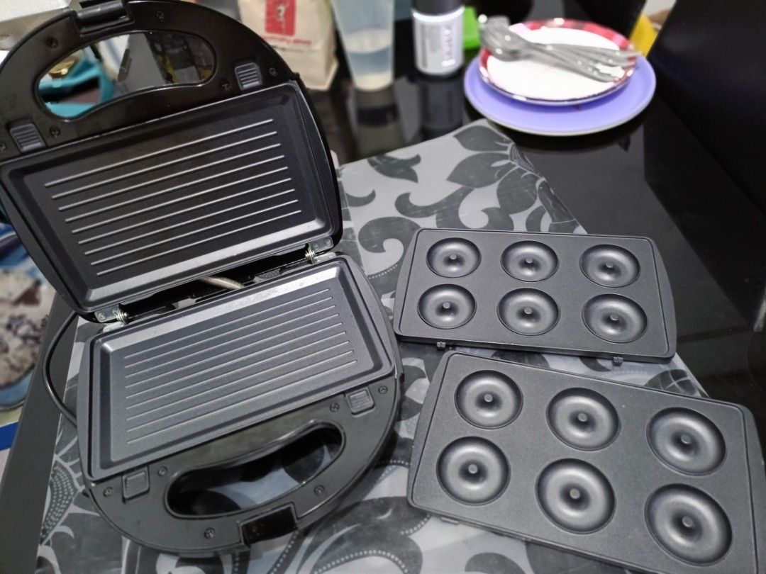 Sandwich maker (Category: Coffee & Tea Tableware) located in Makati City. Submitted by tabsilog (Listing ID 1398331826, Image 3). Description: This is a Tough Mama 3-in-1 sandwich, waffle, and donut maker. It is also sometimes referred to as a griller or a press. The model number is NTM-SG3IN1. It has detachable, non-stick plates for easy cleaning. The appliance has a power rating of 750 watts. It features indicator lights, a safety lock, and coo