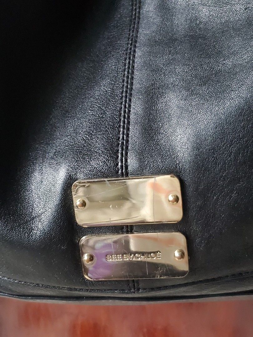 See by Chloé Black Leather two way bag (Category: Luxury Bags & Wallets) located in Manila. Submitted by smicolen (Listing ID 1398210932, Image 3). Description: - See by Chloé black leather handbag - Dual top handles - Detachable shoulder strap - Gold-tone hardware with brand logo - Zipper closure - Signs of wear on handles and hardware - 'SBC' marked zipper pull - pure leather DIMENSIONS: L - 11 W- 11 1/2 Bottom- 7 1/2 sides- 7 .