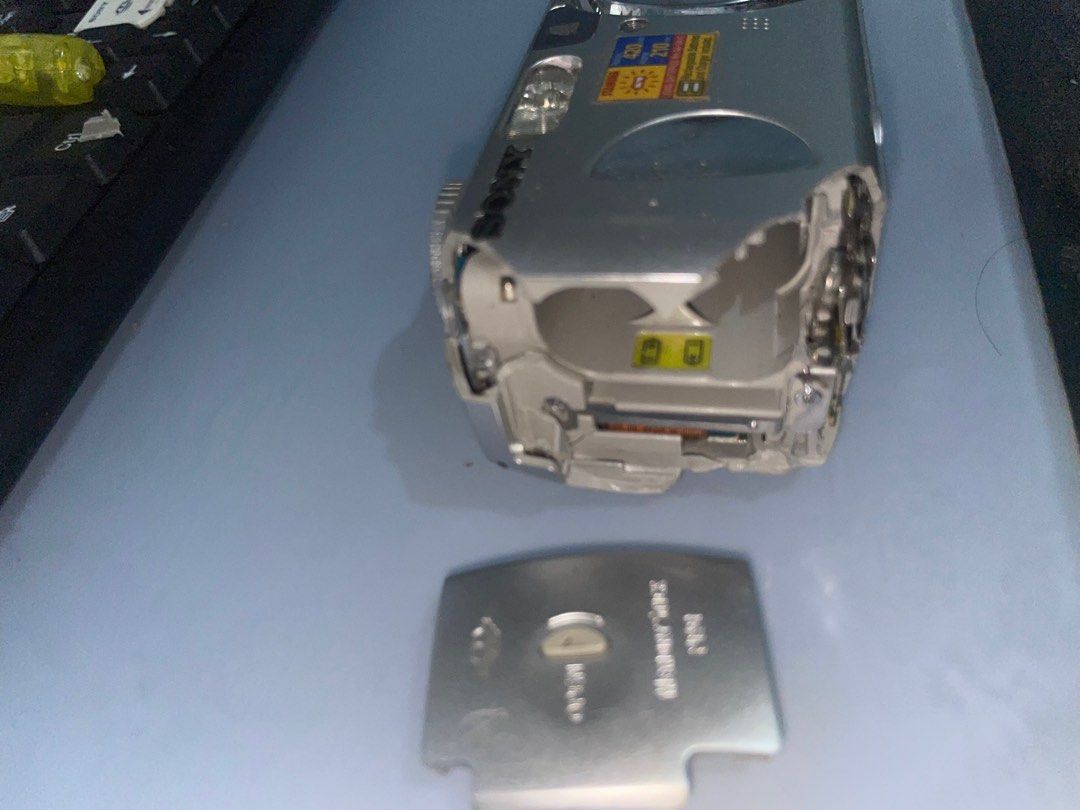 Sony Cyber-shot 4.1MP Digital Camera (Category: Cameras) located in Manila. Submitted by kiagonzale31041 (Listing ID 1398192696, Image 2). Description: - Sony Cyber-shot digital camera - 4.1 megapixels - Silver finish - Model: DSC-P73 - Features a flash - Lens markings: "8-52" - Battery cover is detached -AS IS!! buy on your own risk -camera parts -can lower the price.