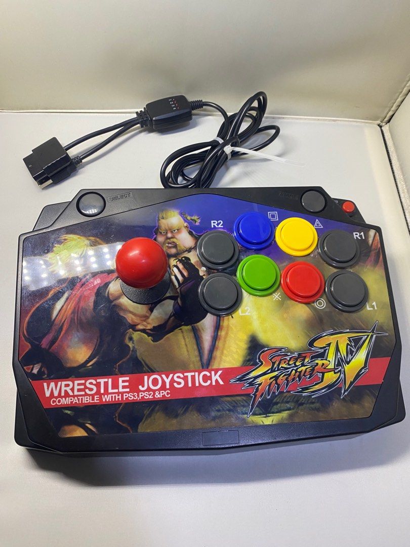 Street Fighter IV Wrestle Joystick (Category: Controllers) located in Pasacao. Submitted by wengpullar37205 (Listing ID 1398270974, Image 2). Description: - Compatible with PS3, PS2, and PC - Features Street Fighter IV graphics - Red joystick and multiple colored buttons - Black body - Wired connection - Includes a QC sticker.