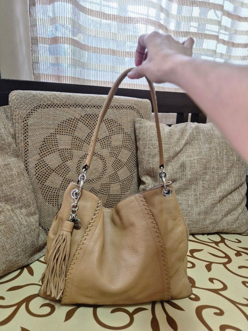 Tan Leather Hobo Bag with Tassel (Category: Shoulder Bags) located in Quezon City. Submitted by jermiahh (Listing ID 1398025019, Image 3). Description: - Tan leather hobo bag - Stitched handle - Stylish tassel - Soft, slouchy design - Silver-tone hardware - Comfortable shoulder strap - Versatile for everyday use - Neutral color.