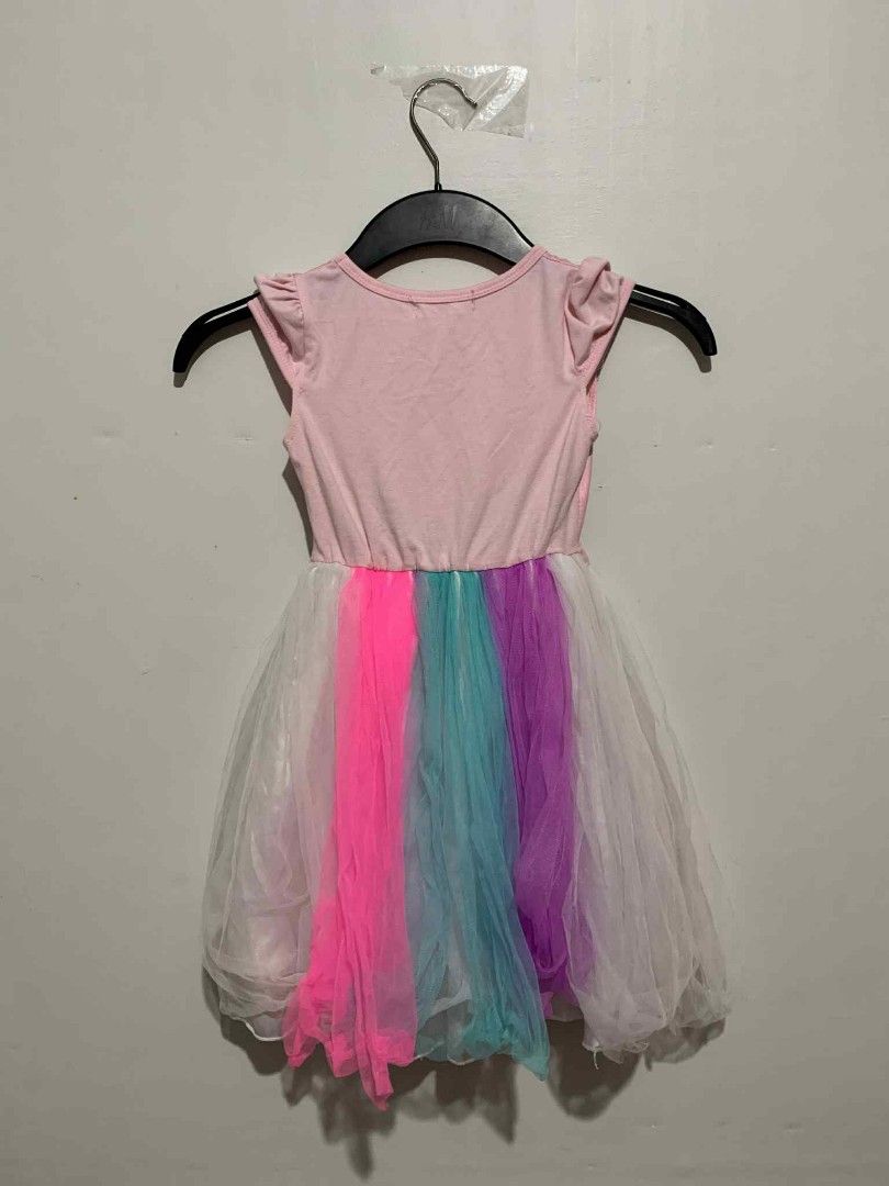 Tiny Love Peppa Pig Rainbow Dress (Category: Babies & Kids Fashion) located in Manila. Submitted by fasthawk-6aae (Listing ID 1398220949, Image 2). Description: Adorable Tiny Love dress featuring Peppa Pig and a rainbow design. The dress has a pink bodice and a colorful tulle skirt with pink, blue, and purple panels. It includes a ribbon at the waist..