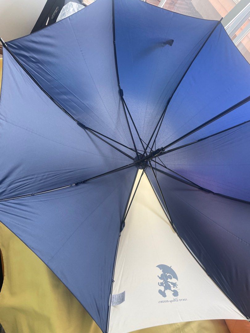Tokyo Disney Resort Mickey Mouse Umbrella (Category: Umbrellas) located in Manila. Submitted by winnieyols (Listing ID 1398249225, Image 2). Description: TOKYO DISNEY RESORT UMBRELLA Umbrella features a navy blue and white design with a Mickey Mouse graphic and the Tokyo Disney Resort logo. The umbrella has a curved handle . Bought inside the Tokyo Disney Resort . - PHP 900.00 RFS: HELPING MY SISTER DECLUTTER HER UMBRELLA COLLECTION MOP: BPI BOOK