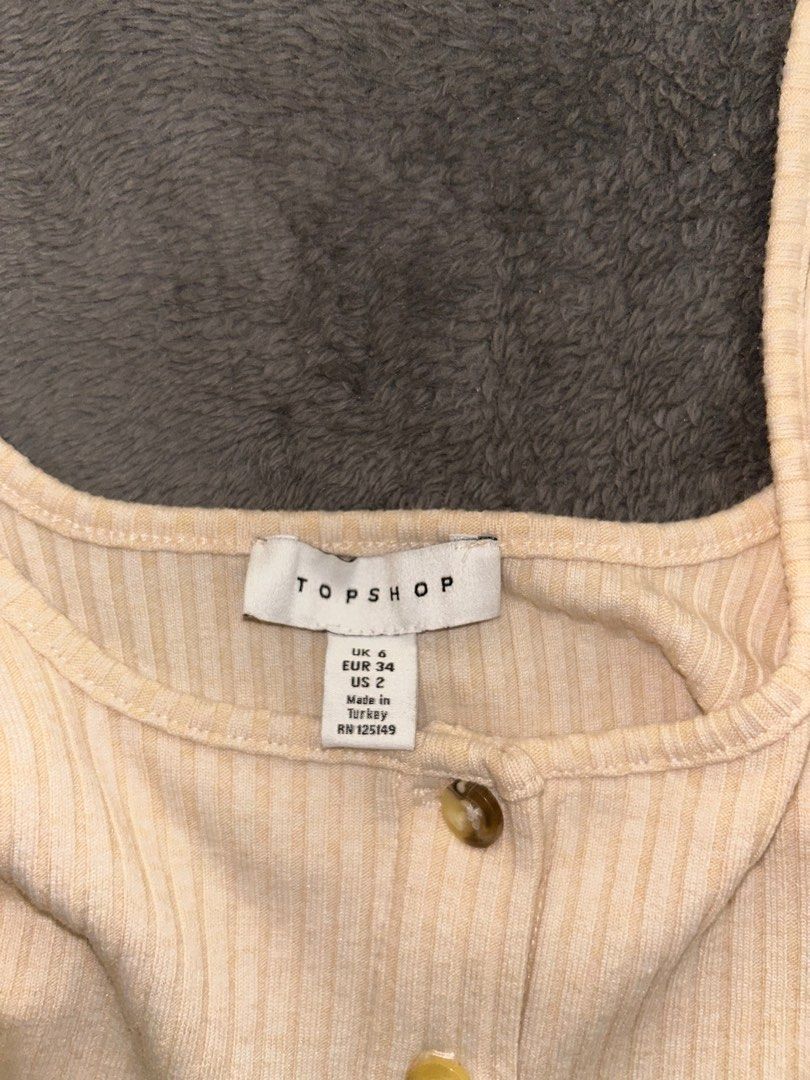 Topshop Ribbed Crop Top (Category: Shirts) located in Binan City. Submitted by mid.elle (Listing ID 1398215814, Image 2). Description: - Topshop cream crop top - Ribbed texture - Button-up front - Wide straps - UK size 4 / US size 2 -See when worn photo .