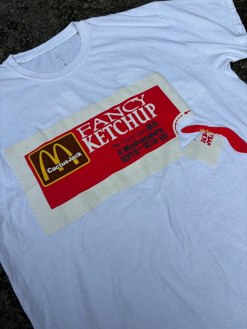 Travis Scott x McDonald's Ketchup T-shirt (Category: Tshirts & Polo Shirts ) located in Manila. Submitted by lanzer30 (Listing ID 1398235108, Image 3). Description: - Travis Scott x McDonald's T-shirt - Size: L - Design: Ketchup packet on front - Back design: Red smiley face and "The Travis Scott Meal SEPT 8 OCT 4 2020" text.