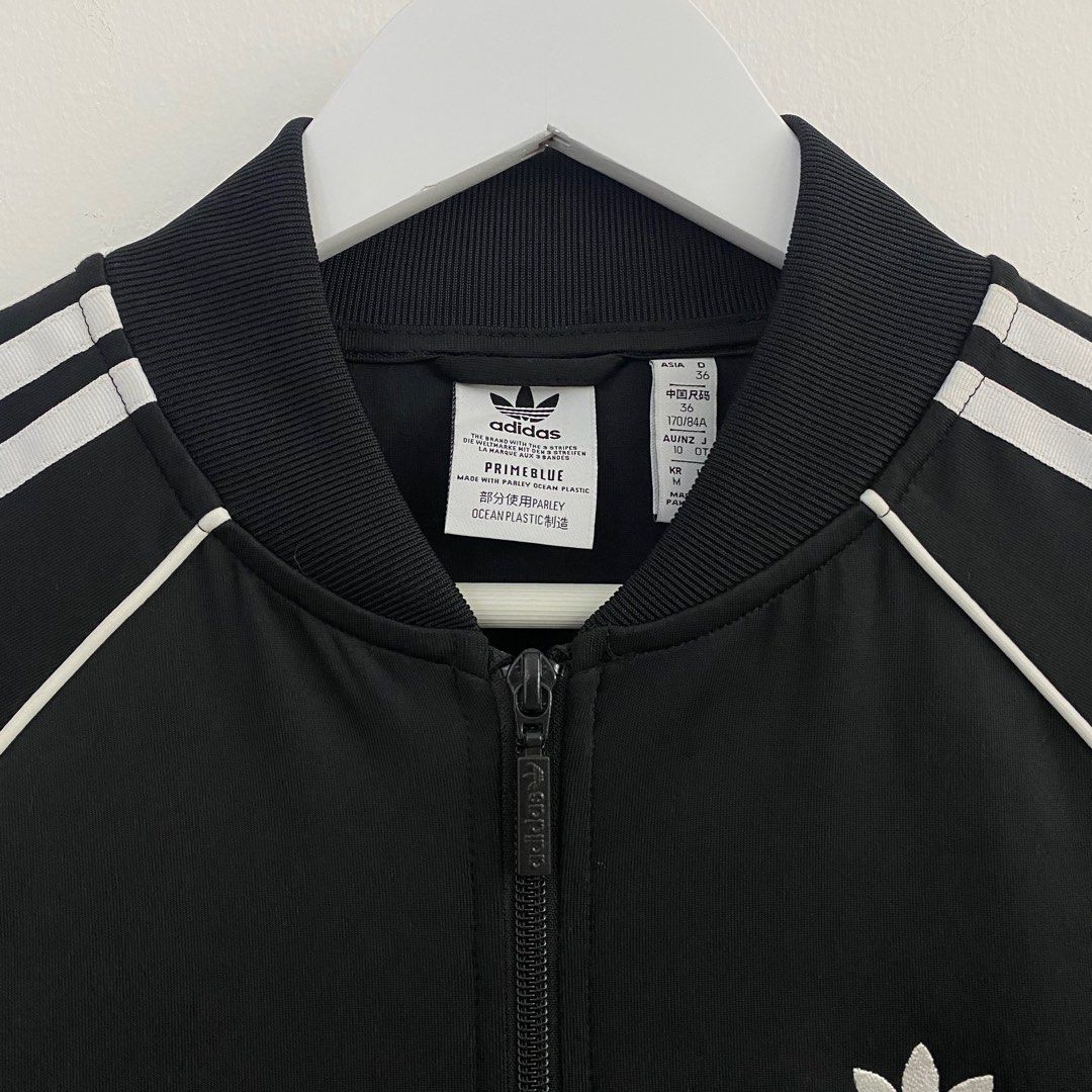 Adidas SST Track Top Primeblue Black (Category: Coats, Jackets and Outerwear) located in Cavite. Submitted by mana__ (Listing ID 1398509980, Image 2). Description: - Adidas SST track top - Black with white stripes - Size M - Full zip closure - Two front pockets - Adidas trefoil logo - Made with Primeblue (Parley Ocean Plastic) - Ribbed collar, cuffs, and hem - Made in Pakistan -DIMENSION Width - 19.5 Length - 26 Shoulders - 17 Sleeve - 23.5.