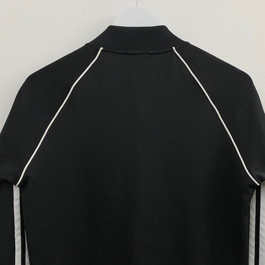 Adidas SST Track Top Primeblue Black (Category: Coats, Jackets and Outerwear) located in Cavite. Submitted by mana__ (Listing ID 1398509980, Image 3). Description: - Adidas SST track top - Black with white stripes - Size M - Full zip closure - Two front pockets - Adidas trefoil logo - Made with Primeblue (Parley Ocean Plastic) - Ribbed collar, cuffs, and hem - Made in Pakistan -DIMENSION Width - 19.5 Length - 26 Shoulders - 17 Sleeve - 23.5.