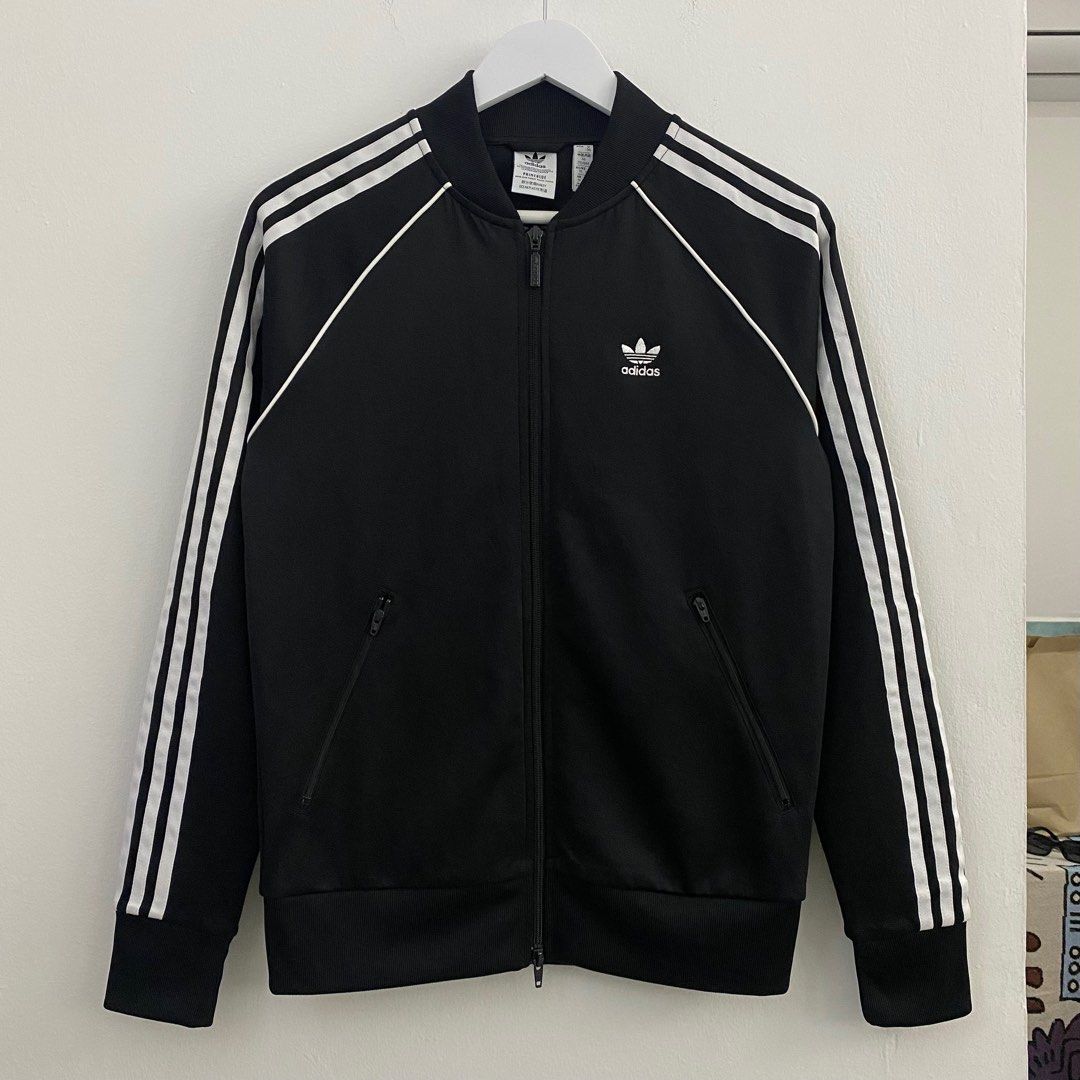 Adidas SST Track Top Primeblue Black (Category: Coats, Jackets and Outerwear) located in Cavite. Submitted by mana__ (Listing ID 1398509980, Image 1). Description: - Adidas SST track top - Black with white stripes - Size M - Full zip closure - Two front pockets - Adidas trefoil logo - Made with Primeblue (Parley Ocean Plastic) - Ribbed collar, cuffs, and hem - Made in Pakistan -DIMENSION Width - 19.5 Length - 26 Shoulders - 17 Sleeve - 23.5.