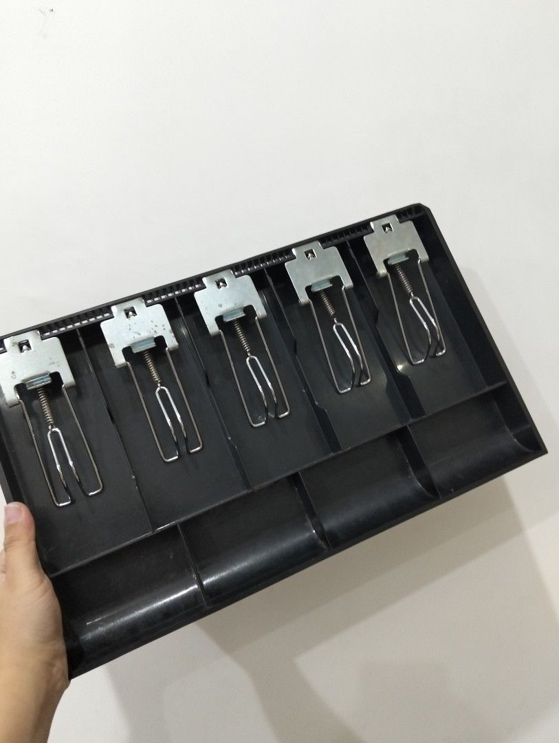 Cash Register Tray (Category: Office Furniture & Fixtures) located in Manila. Submitted by katrinasfa27852 (Listing ID 1398457916, Image 1). Description: - Black cash register tray - Five compartments - Metal spring-loaded clips - Ideal for cash and receipt organization - Practical for point-of-sale systems.