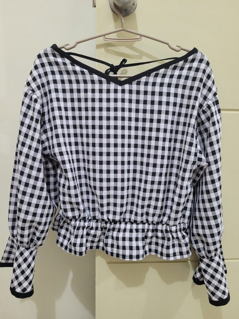Checkered Blouse (Category: Blouses) located in Los Banos. Submitted by momo_mono (Listing ID 1398471560, Image 2). Description: - MAJESTIC LEGON blouse - Size: M - Classic black and white gingham pattern - Long sleeves with flared cuffs - Gathered waist - V-neckline with tie detail rfs: declutter.