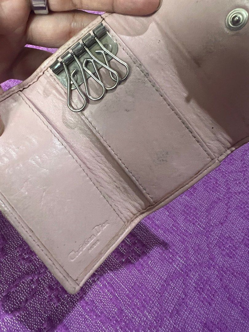 Christian Dior Key Holder (Category: Luxury Bags & Wallets) located in Quezon City. Submitted by kayesantos7 (Listing ID 1398392571, Image 2). Description: - Authentic Christian Dior key holder - Features the iconic pink and beige Dior Oblique pattern - Adorned with a bow detail and 'D' charm - Interior crafted from pink leather - Includes key hooks Selling my Christian Dior trotter pink keycase. In good preloved condition. Has signs of usage alr